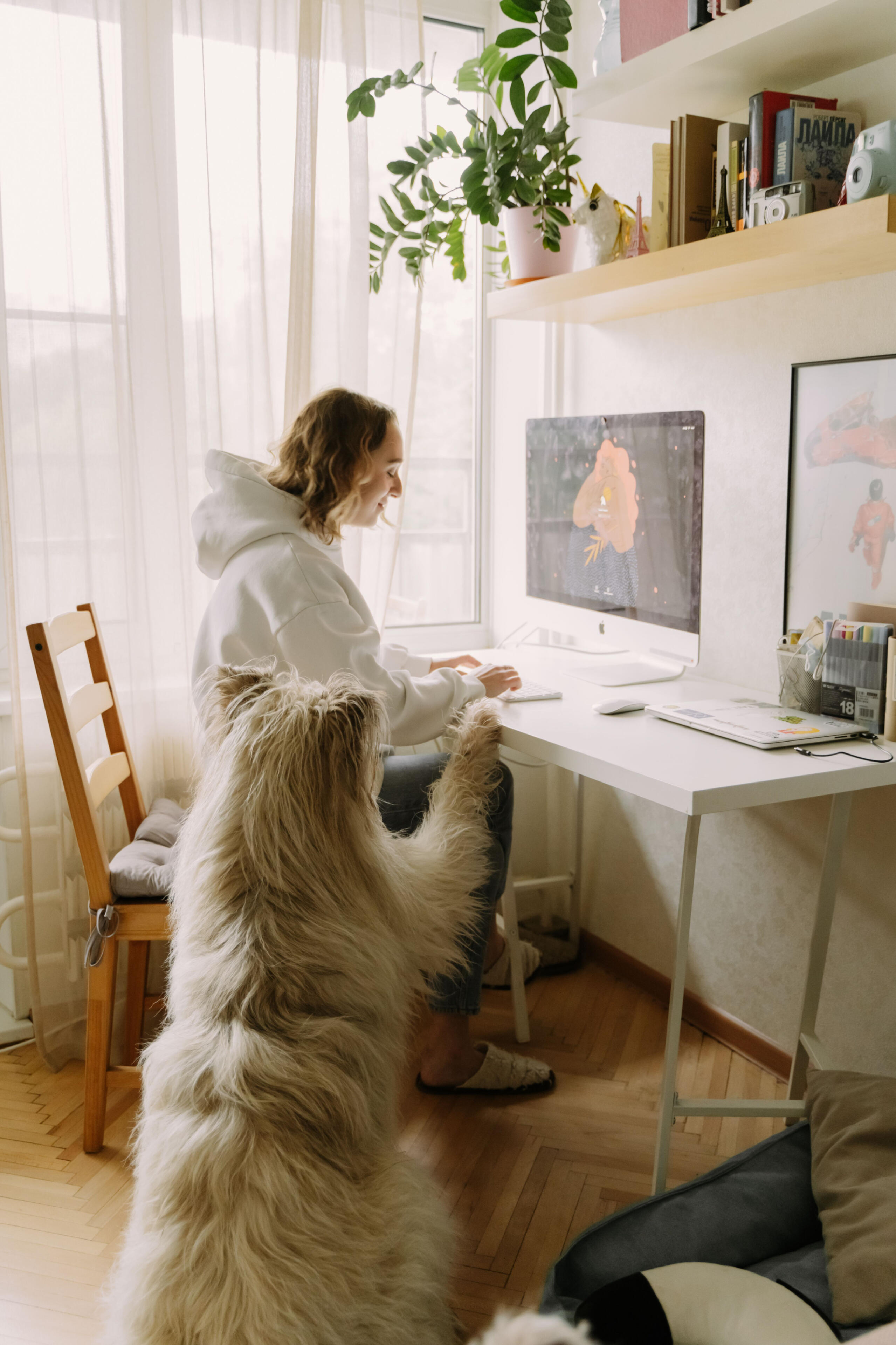 Woman working at home with her dog beside her